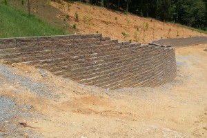 Retaining Wall Installed To Stabilize Hillside Above Driveway